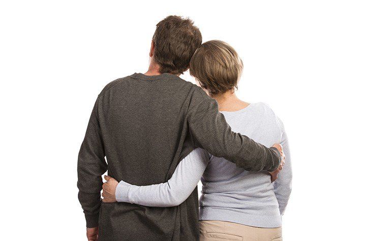 Caucasian middle-aged couple giving a side hug