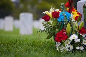 White gravestones and flowers at cemetary for memorial day