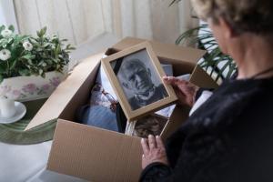 Woman is packing pictures of husband