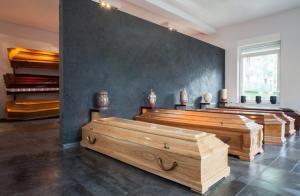 Coffins and urns standing in funeral house