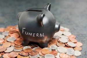 coin piggy-bank with "Funeral" written on it