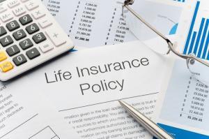 Close up of Life Insurance Policy with pen, calculator