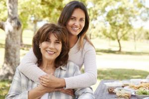 A daughter and senior mother review life insurance options.
