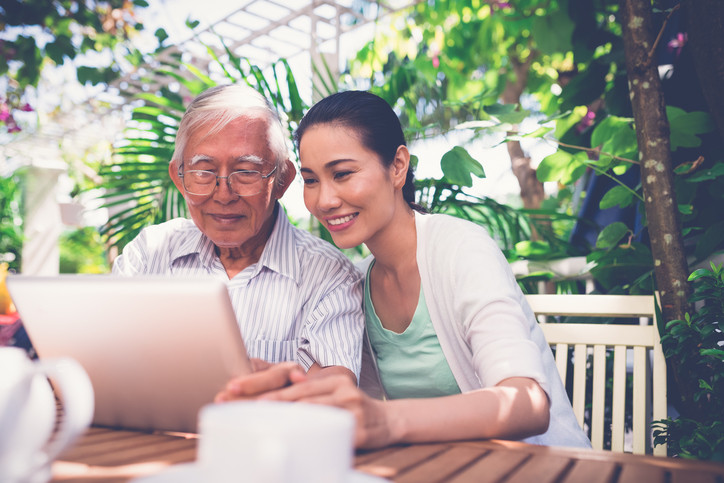 A daughter and her aging father review options for life insurance for seniors.