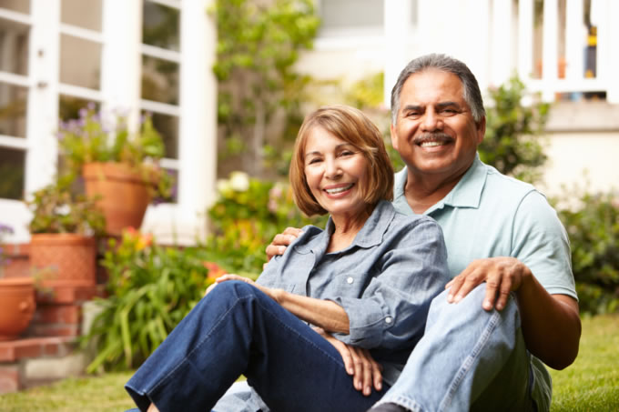 happy couple sitting on lawn