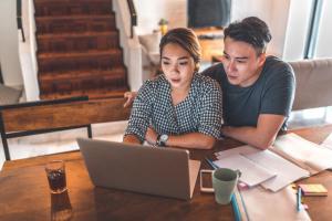 Serious couple using laptop